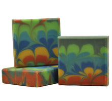 Load image into Gallery viewer, A bar of soap with a colorful floral pattern design, cut and displayed to show the design layers.