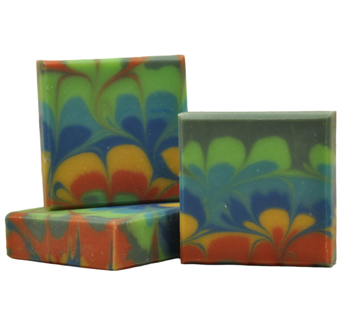 A bar of soap with a colorful floral pattern design, cut and displayed to show the design layers.