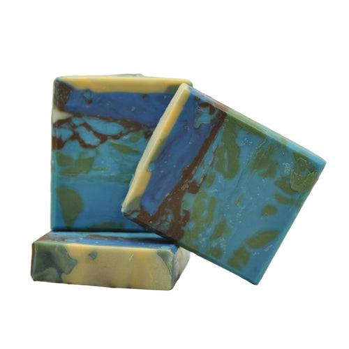 Two blue and green soap bars on a floral background