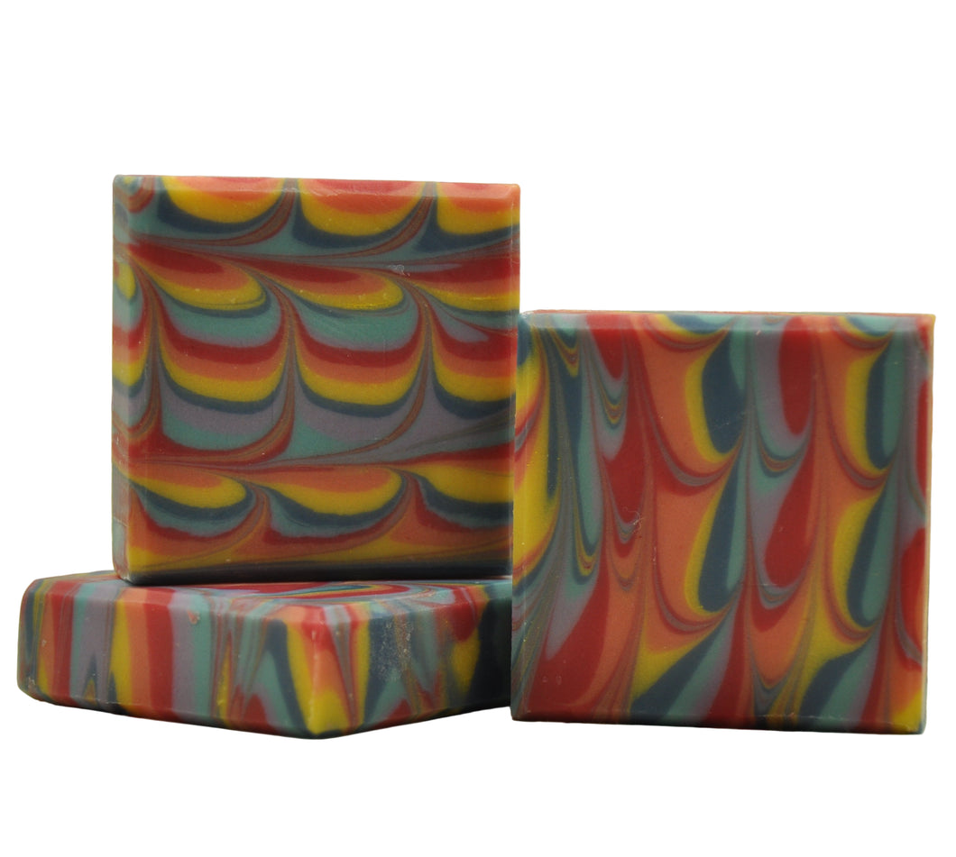 Three colorful swirled soap bars on a floral background