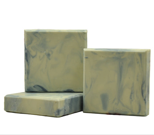 Three bars of soap with a blue white marbled pattern on a white background