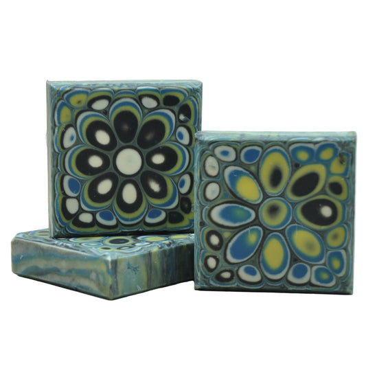 Handmade cold process goat milk soap with a dramatic kaleidoscope mandala in black, white, teal, and gold – Kaleidoscope Midnight natural artisan soap, unique bar